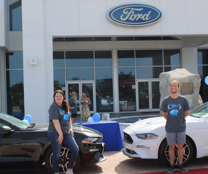 two students with new cars