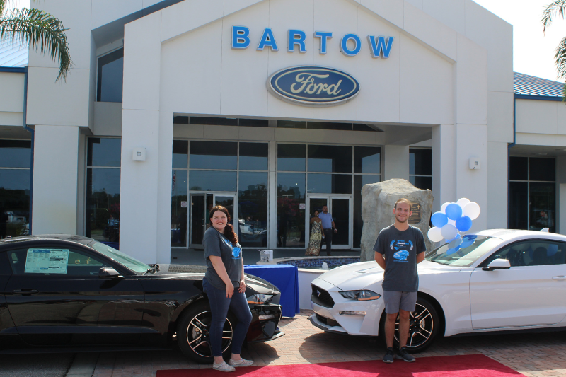 two students with new cars